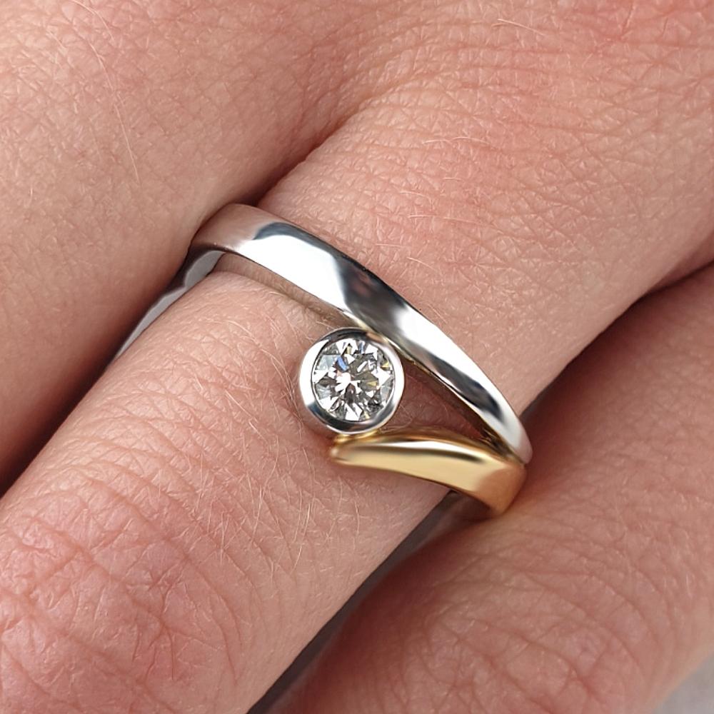 Platinum and gold Flick engagement ring with small round diamond