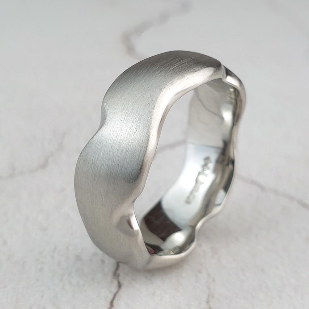 Carved platinum carved wedding ring with matte finish
