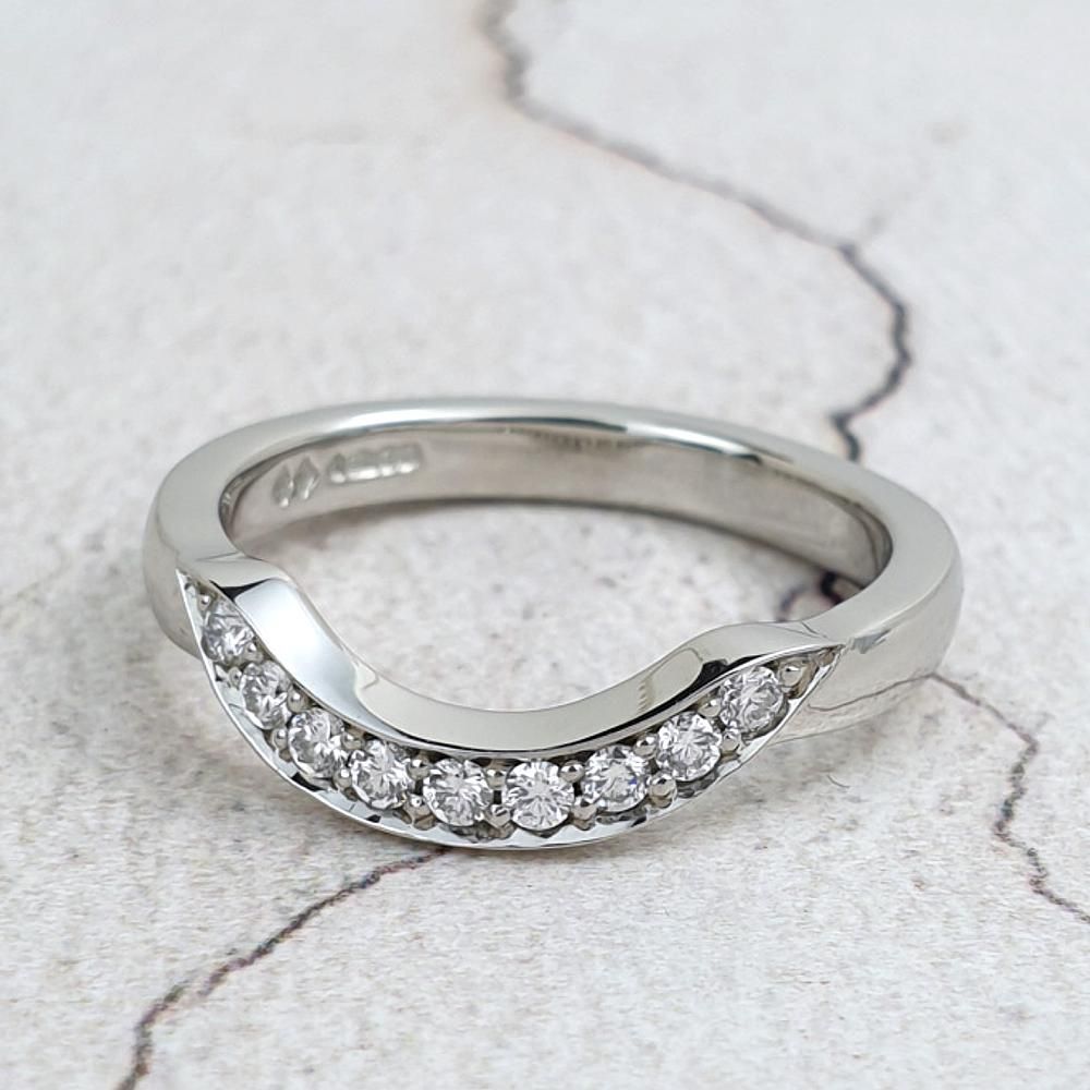 A fitted wedding ring set with diamonds