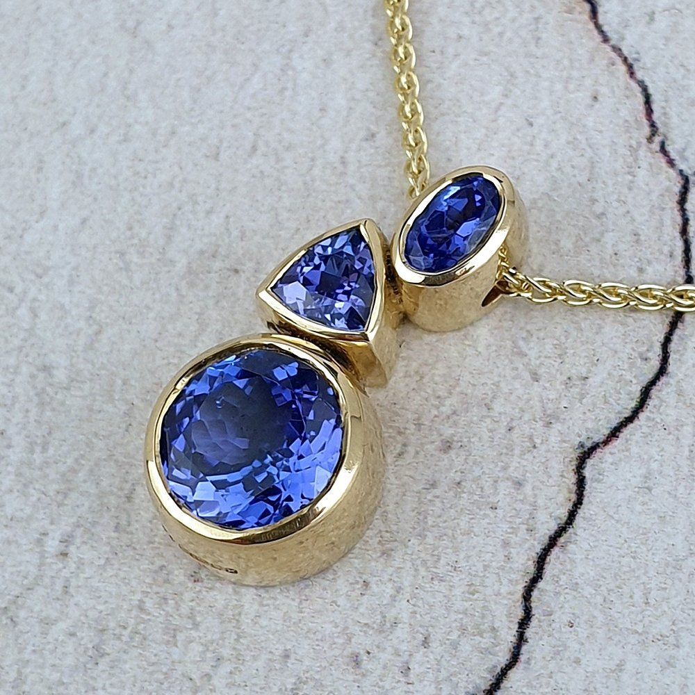 An asymmetric pendant with three different shapes of Tanzanite