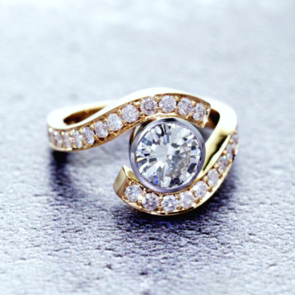 Diamond crossover engagement ring with diamond-set shoulders