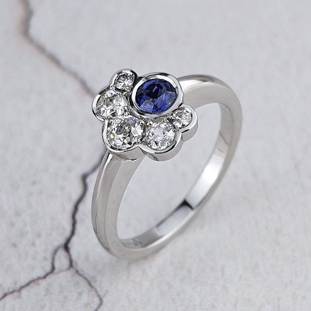 asymmetric platinum ring with one sapphire and five diamonds