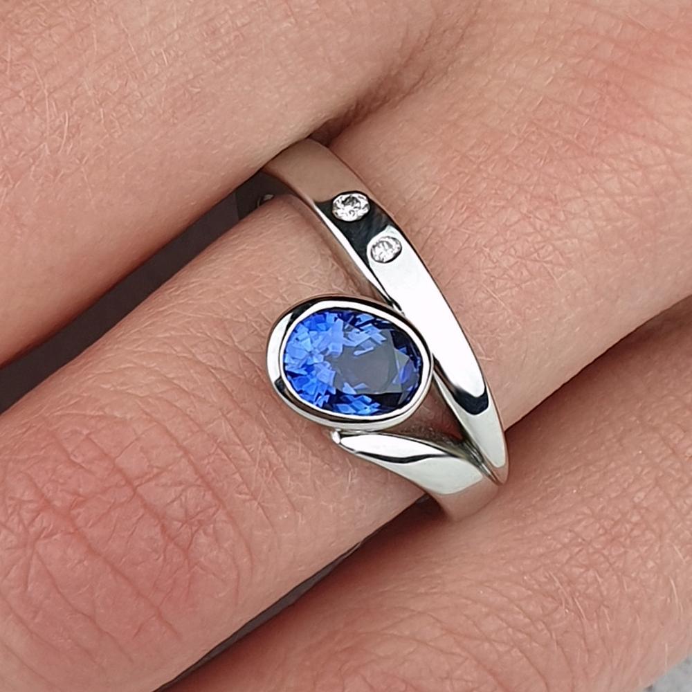 Platinum Flick ring with sapphire and small diamonds