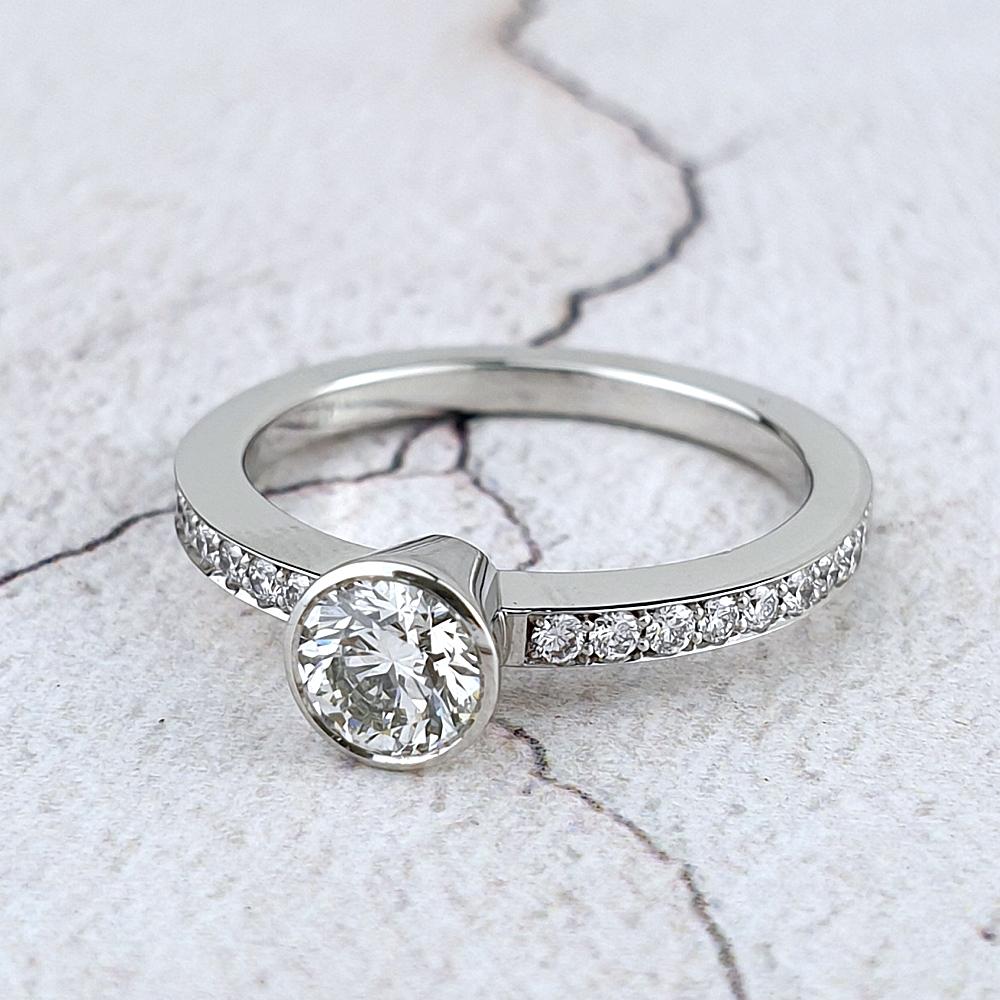 Platinum and diamond solitaire with pavé-set band