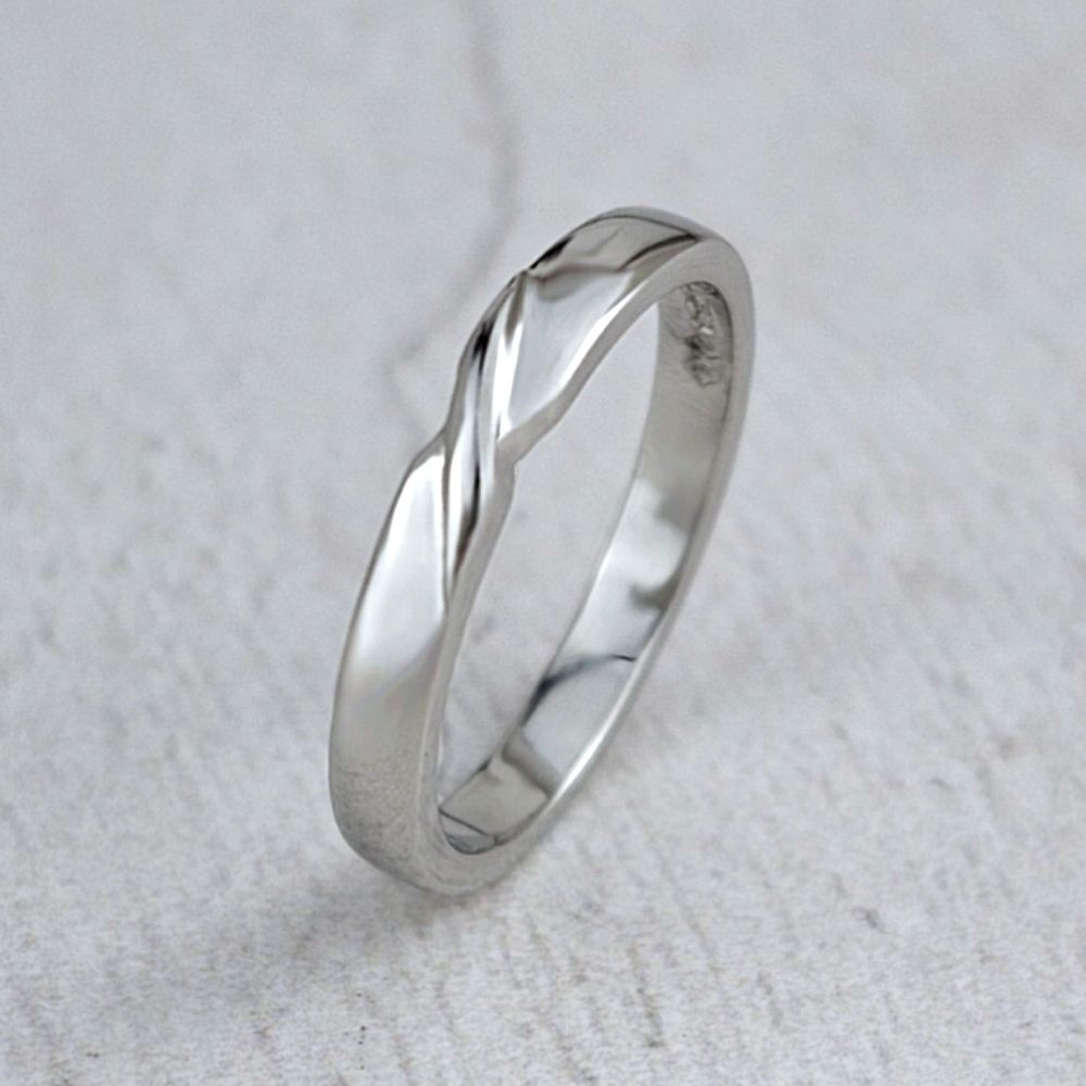 A platinum wedding ring with a twist on the top