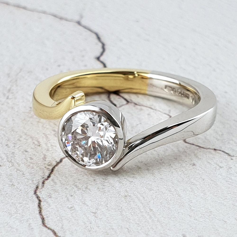 Modern crossover ring in platinum and gold with single diamond