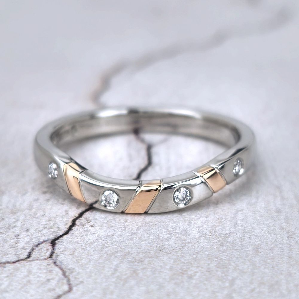 A bespoke wedding ring in platinum with diamonds and red gold