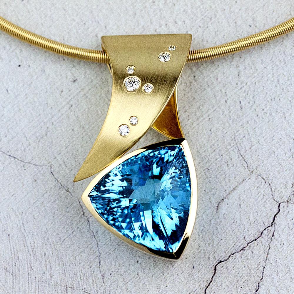 Large gold pendant with blue topaz and scattered diamonds