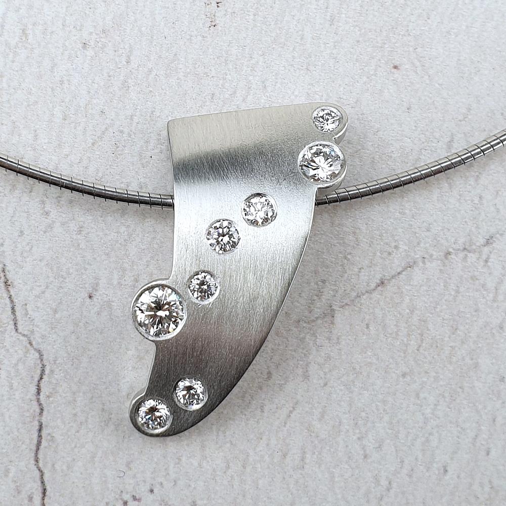 Platinum pendant with scattered diamonds