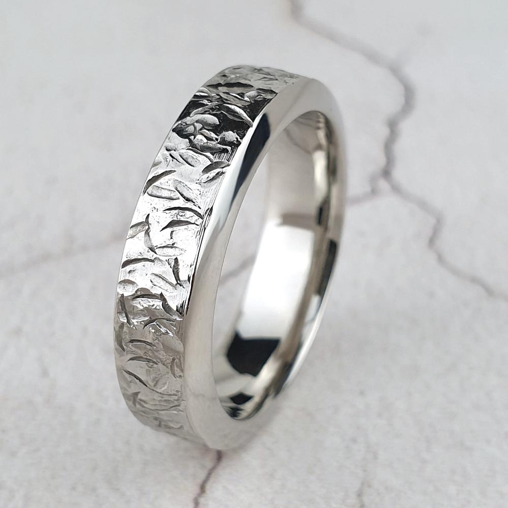 Platinum wedding ring with a rugged texture