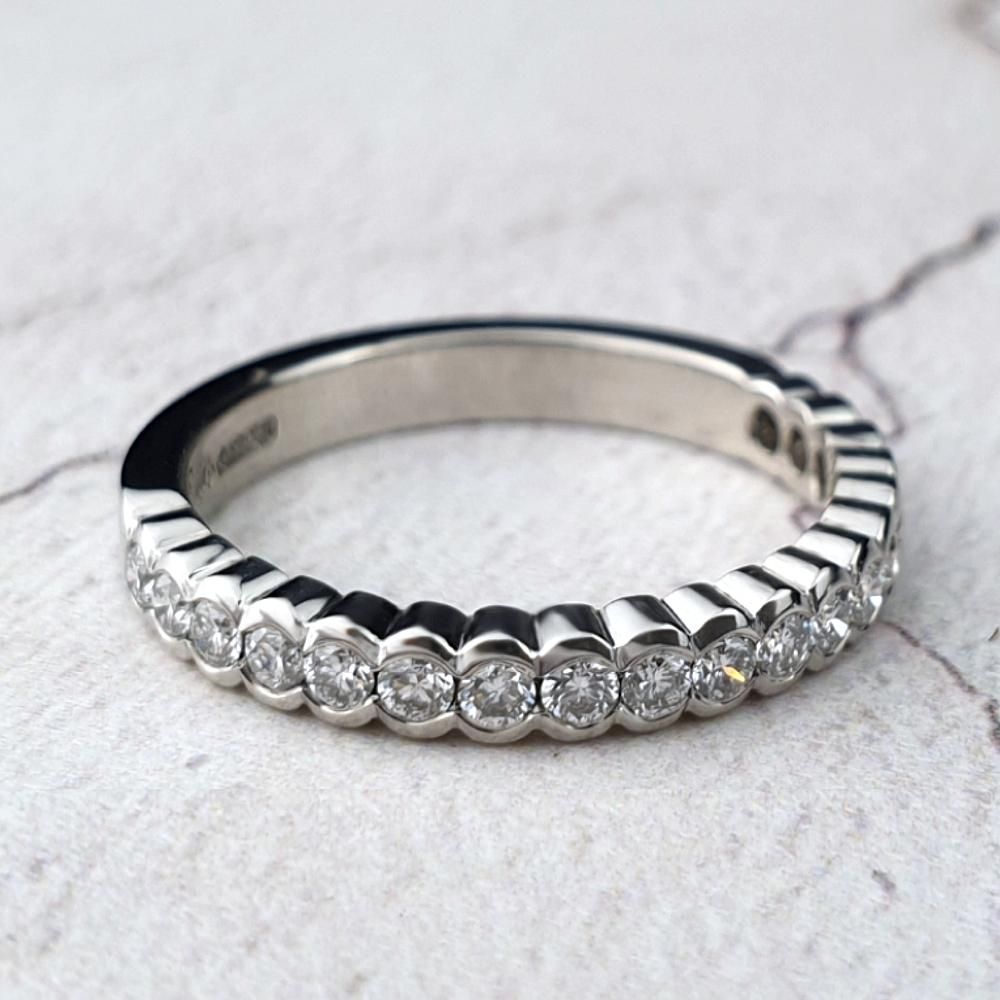 Platinum diamond eternity ring with scalloped edges
