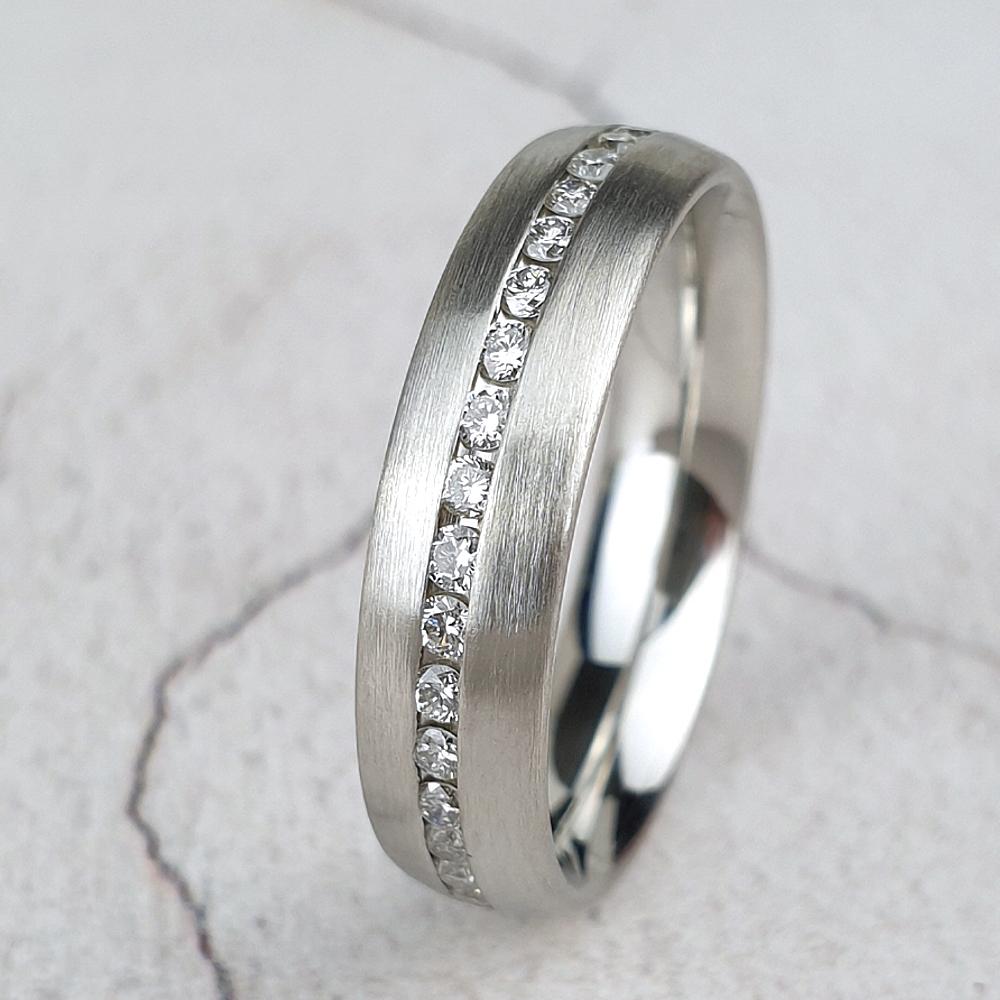 Matte platinum wedding ring with channel set diamonds