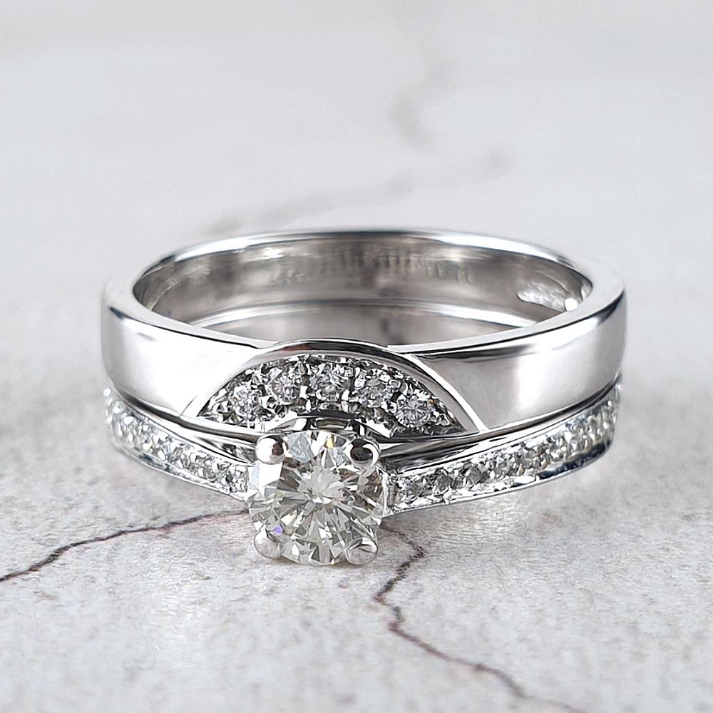 Fitted wedding rings with pavé-set diamonds shown with the engagement ring