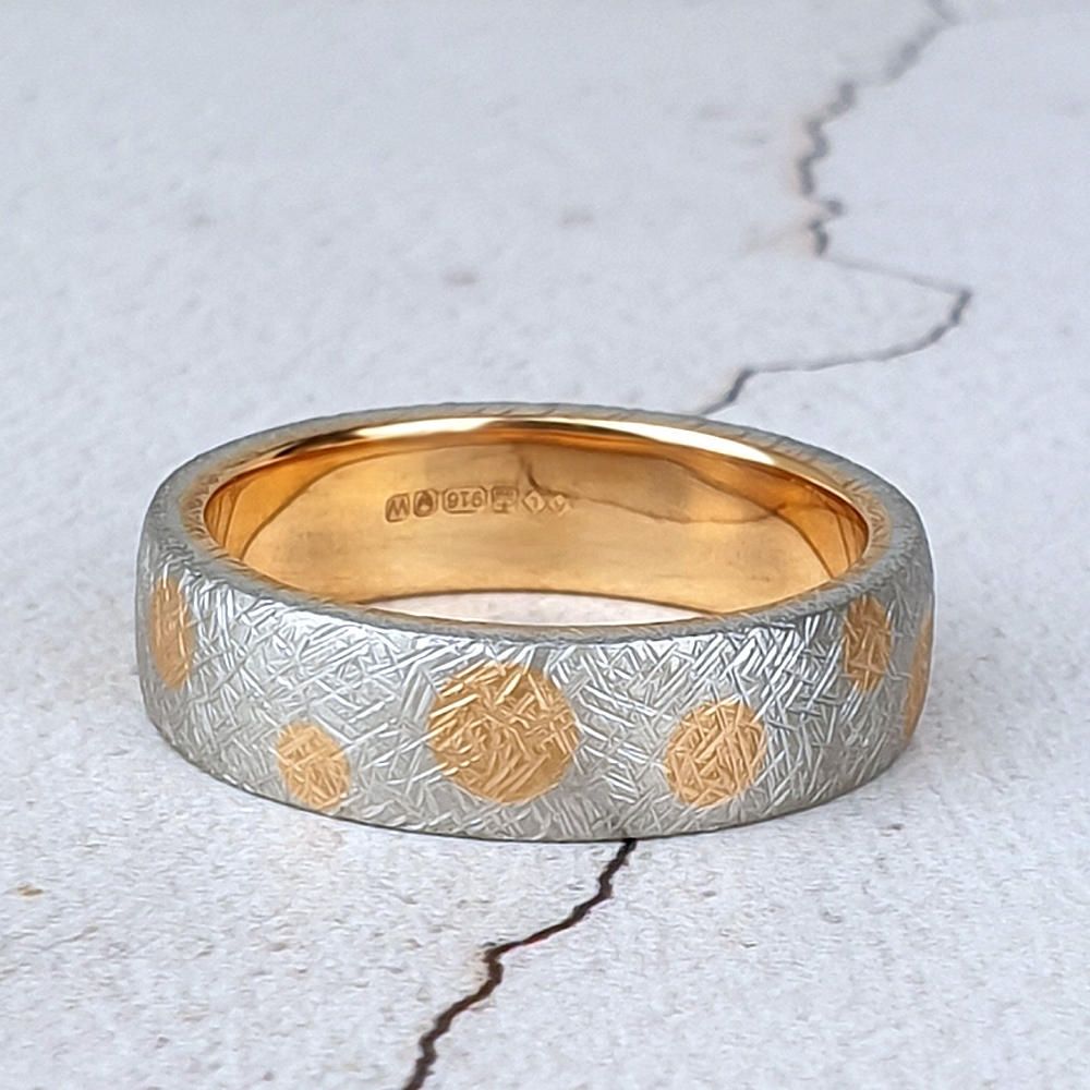 textured platinum wedding ring with gold inside