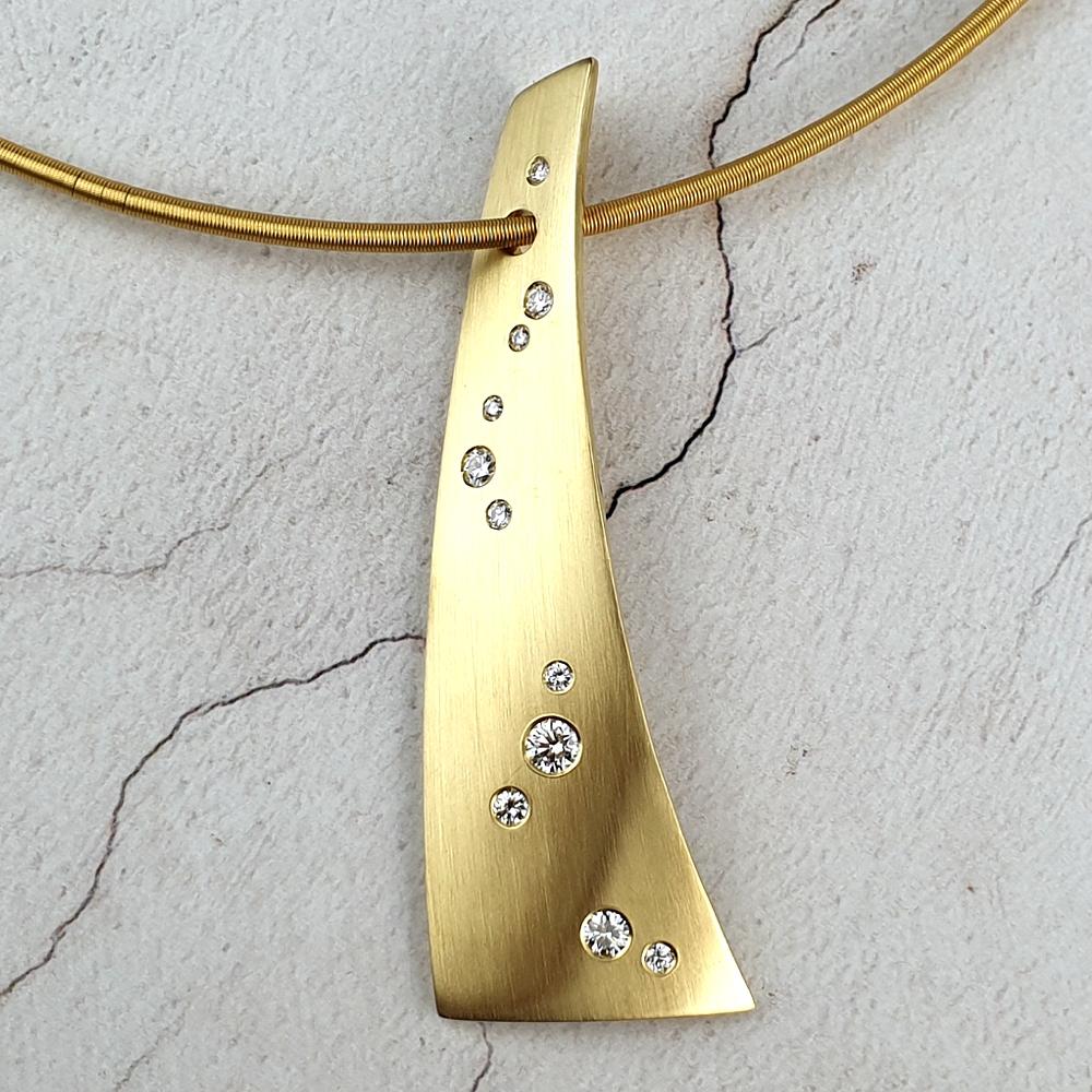 A bespoke gold pendant with scattered diamonds