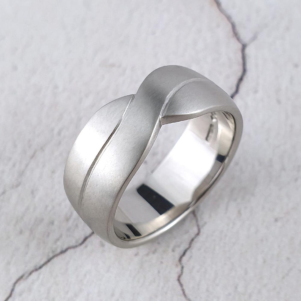 A man's platinum  wedding band with a crossover effect