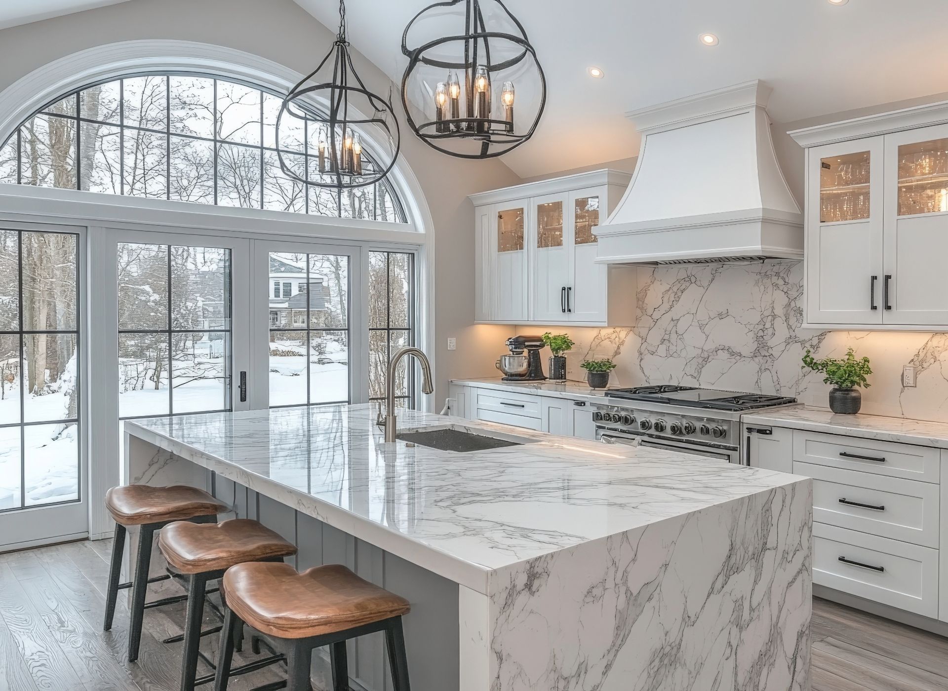 Bright, modern kitchen with large window overlooking a snowy landscape. White cabinetry,