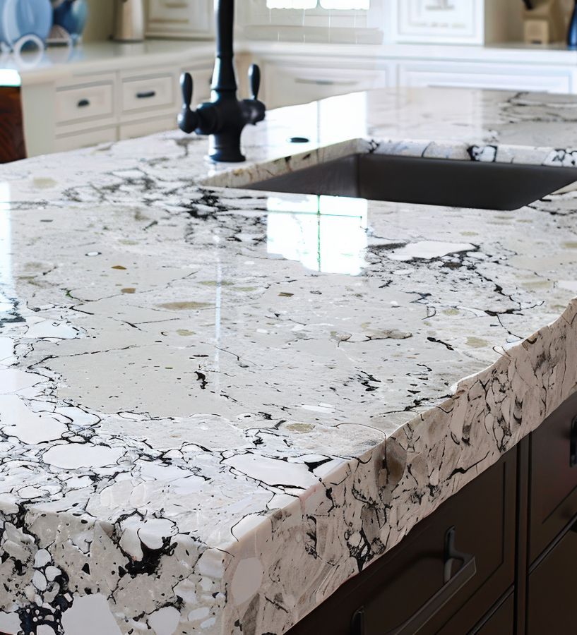 White and black marbled countertop with a black sink, in a kitchen.