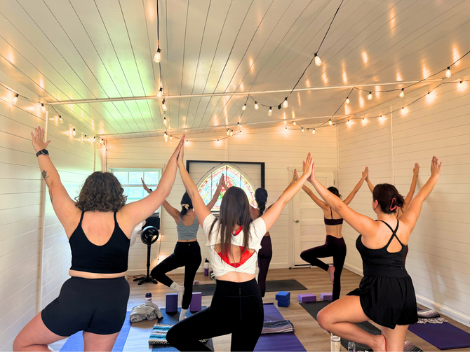 bachelorette party in the yoga barn doing tree pose and holding hands leaning on each other having fun!
