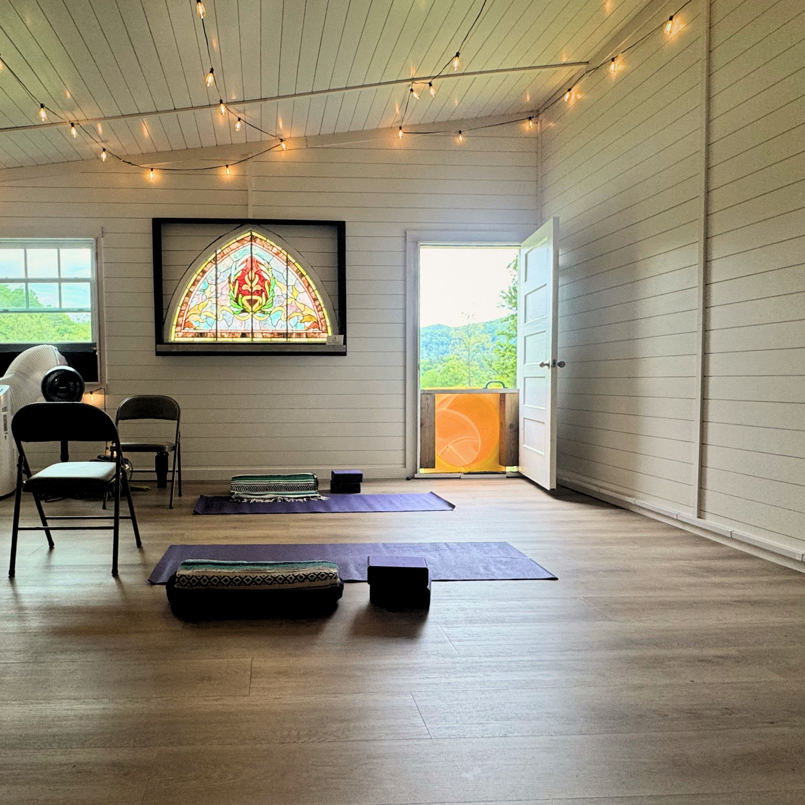 yoga barn with private yoga therapy set up and a view of the lush green mountains on a beautiful summer day