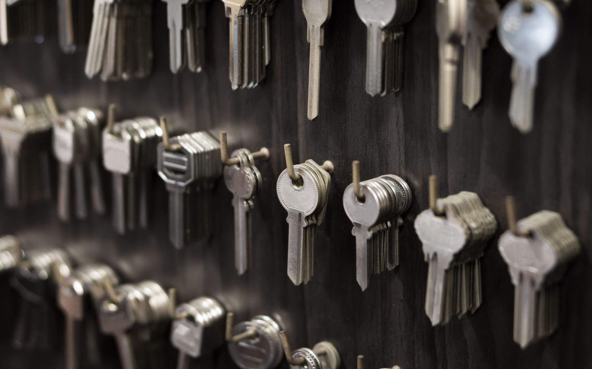 Rows of various silver keys hanging on hooks.