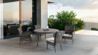 Covered patio with lime-green sectional sofa, red patterned rug, and dark wicker coffee table