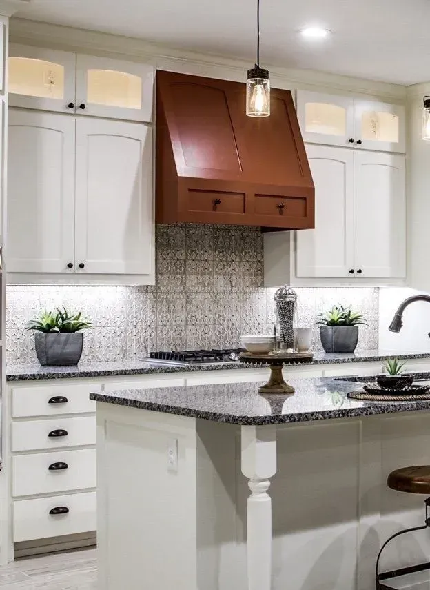 A kitchen with white cabinets and granite counter tops
