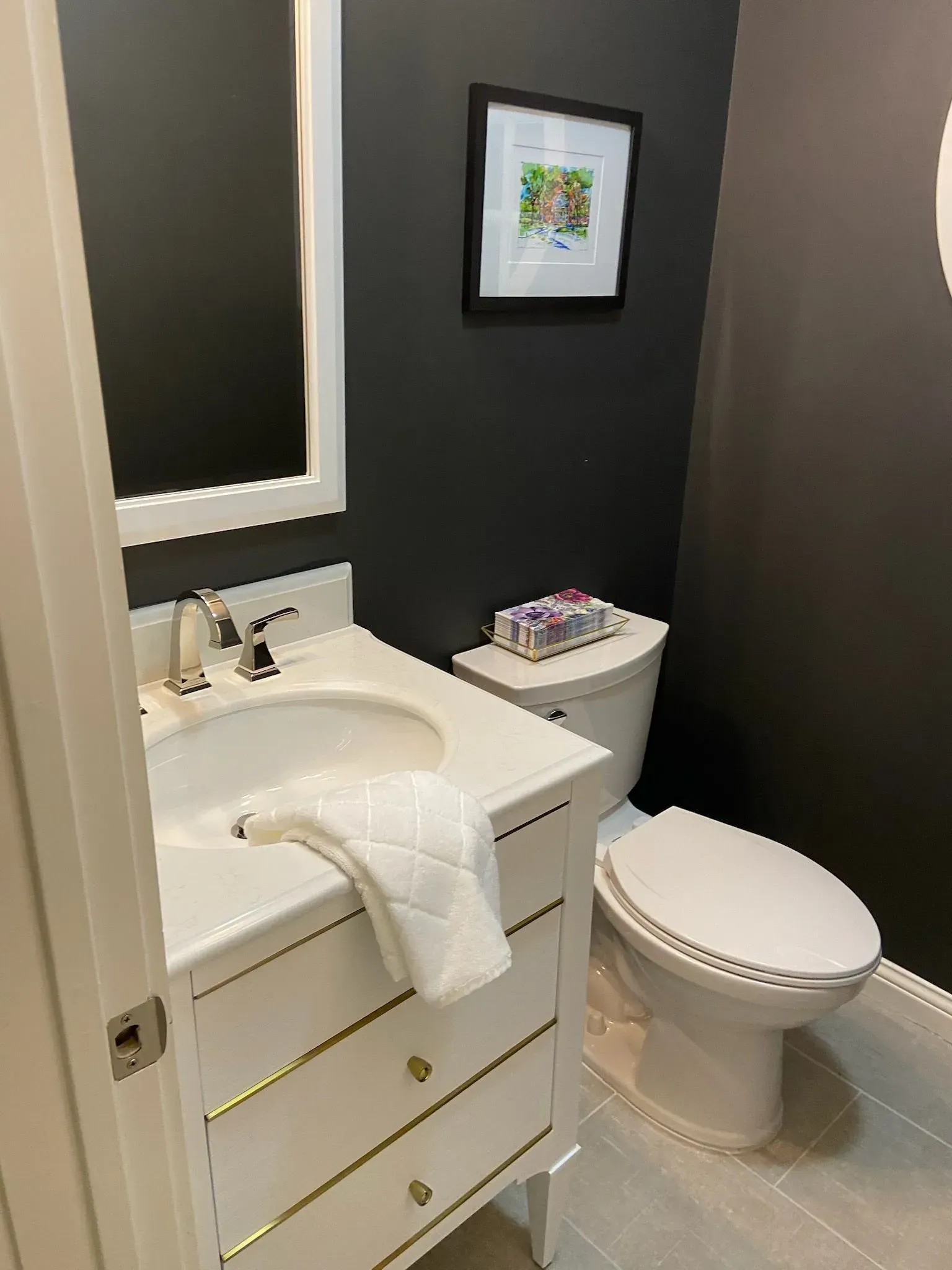 A bathroom with a sink , toilet and mirror.