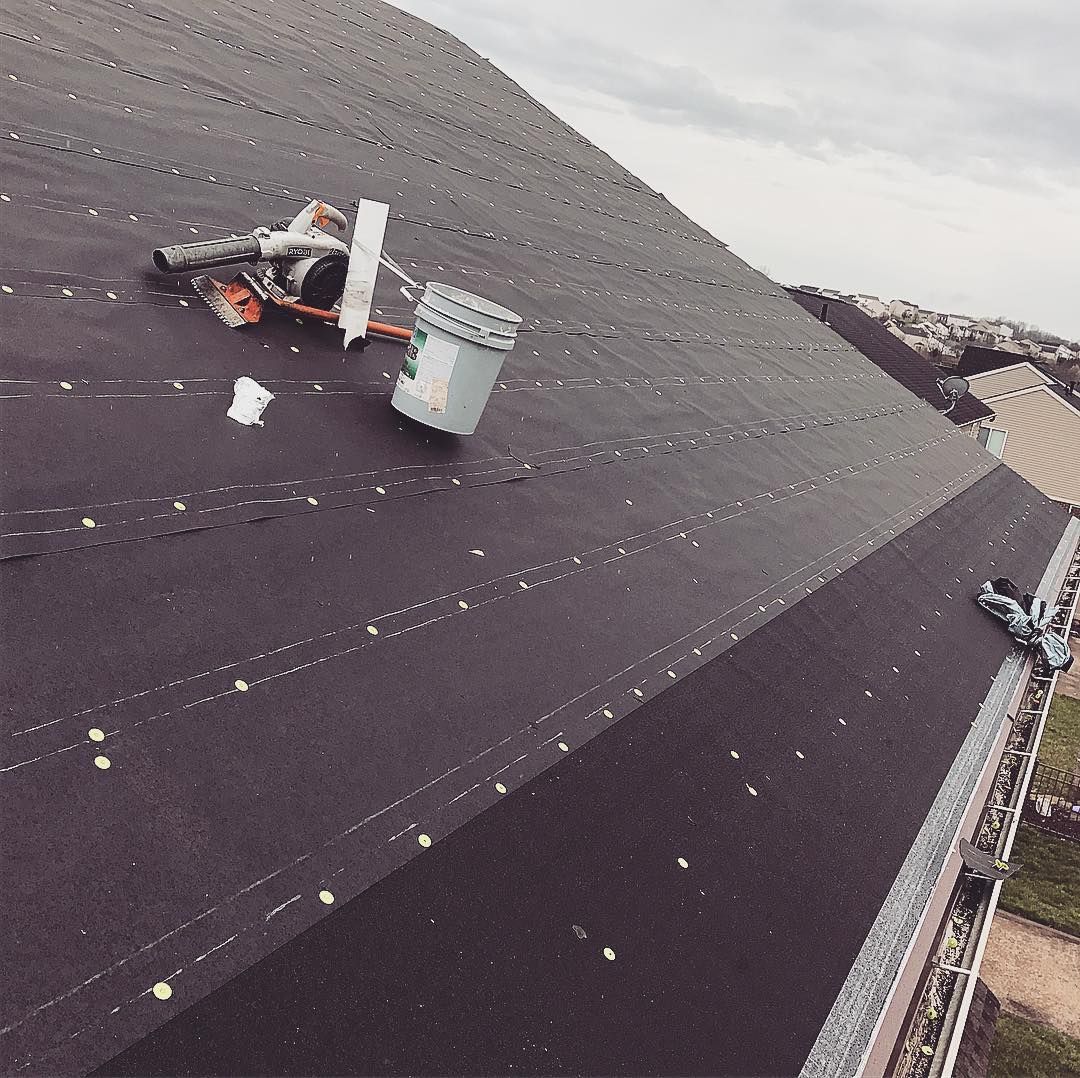 A bucket is sitting on the roof of a building