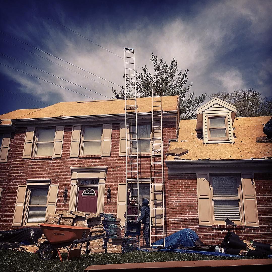 A brick house with a wheelbarrow in front of it