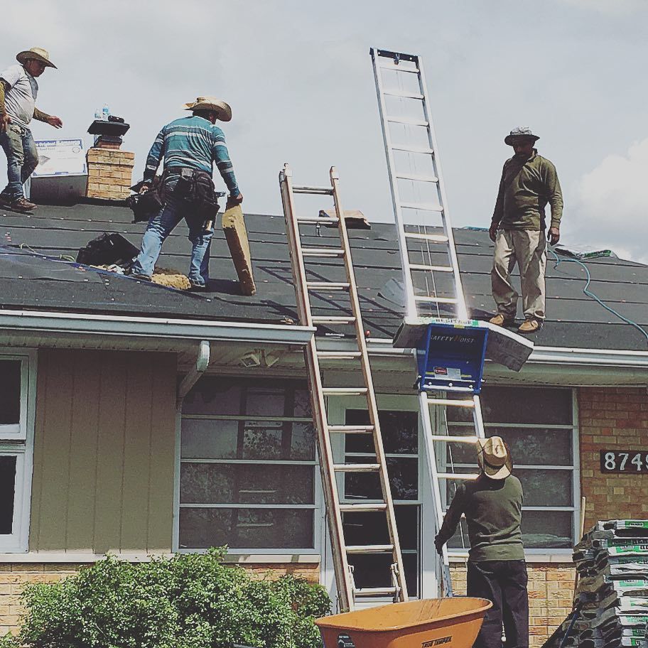 A group of men are working on the roof of a house with a sign that says r741