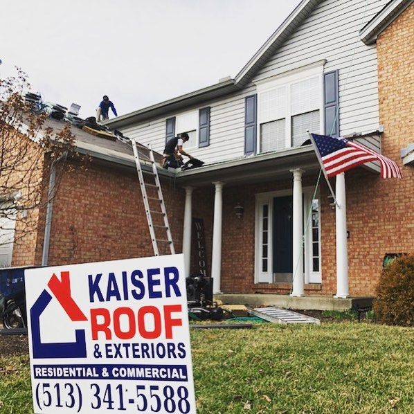 A kaiser roof and exteriors sign in front of a house