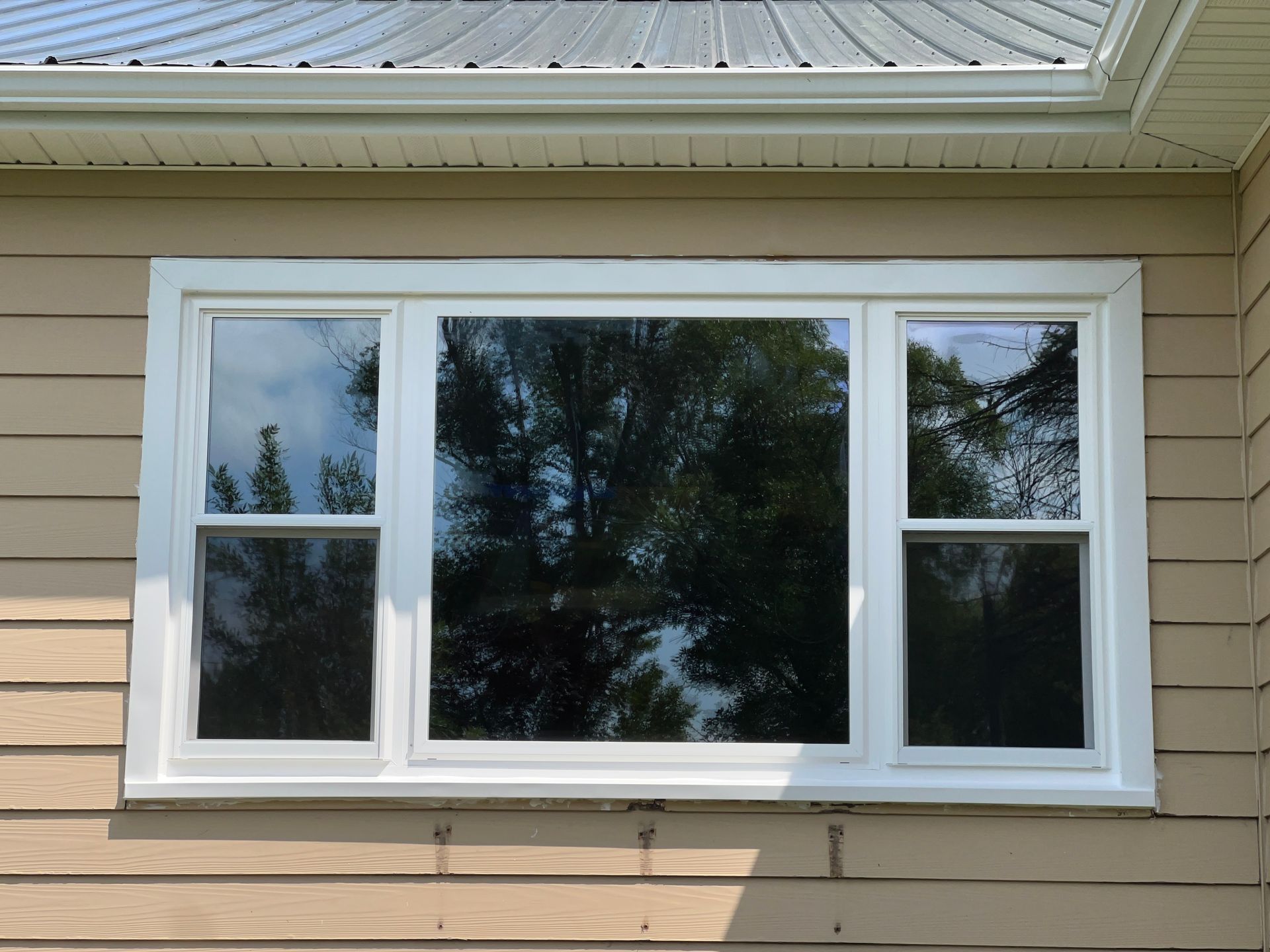 A white window on the side of a house