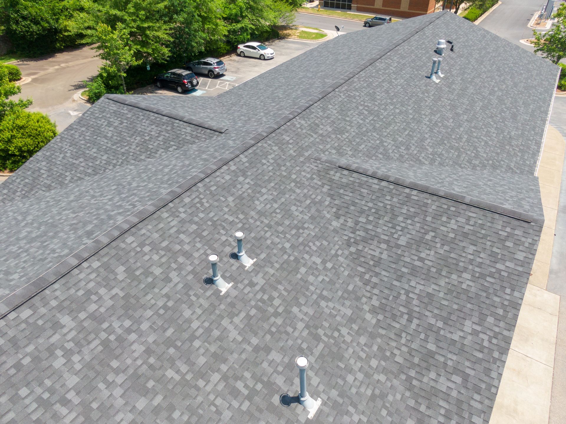 An aerial view of a roof with a lot of vents on it.