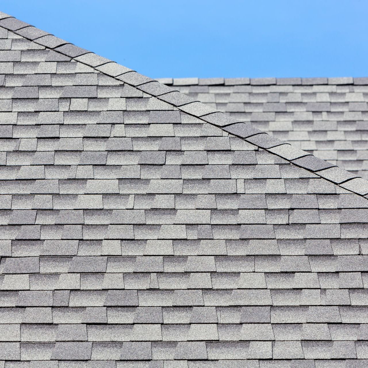 A close up of a roof with a blue sky in the background