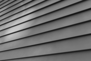 A close up of a gray siding on a house.