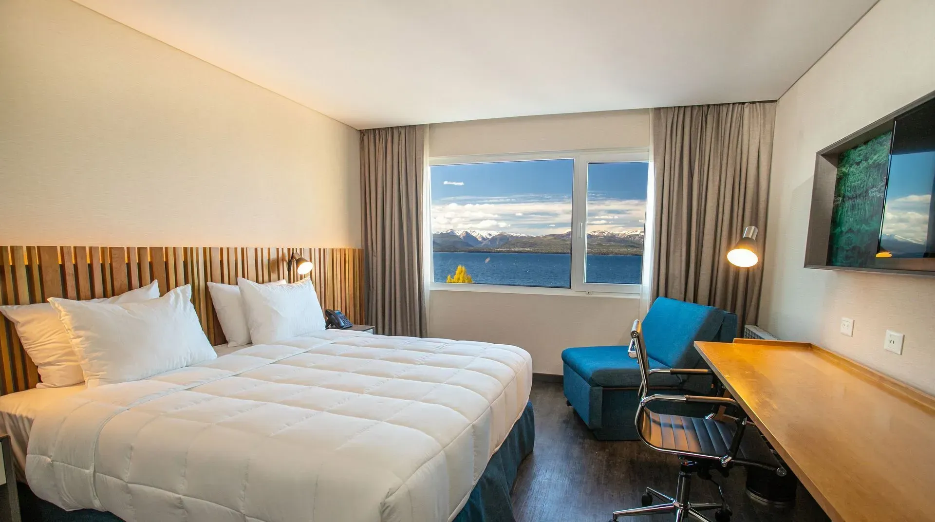 Una habitación de hotel con dos camas, un escritorio y una televisión.