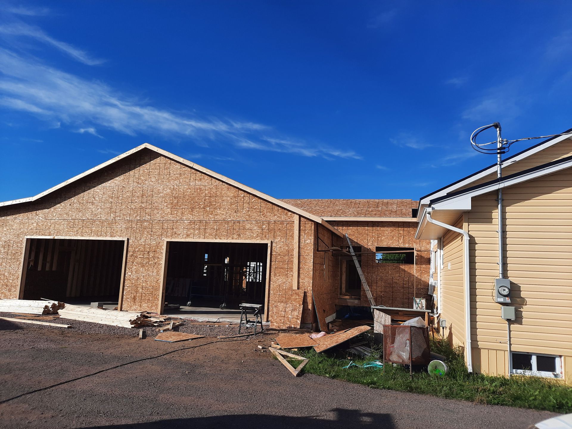 A house that is being built with a blue sky in the background.