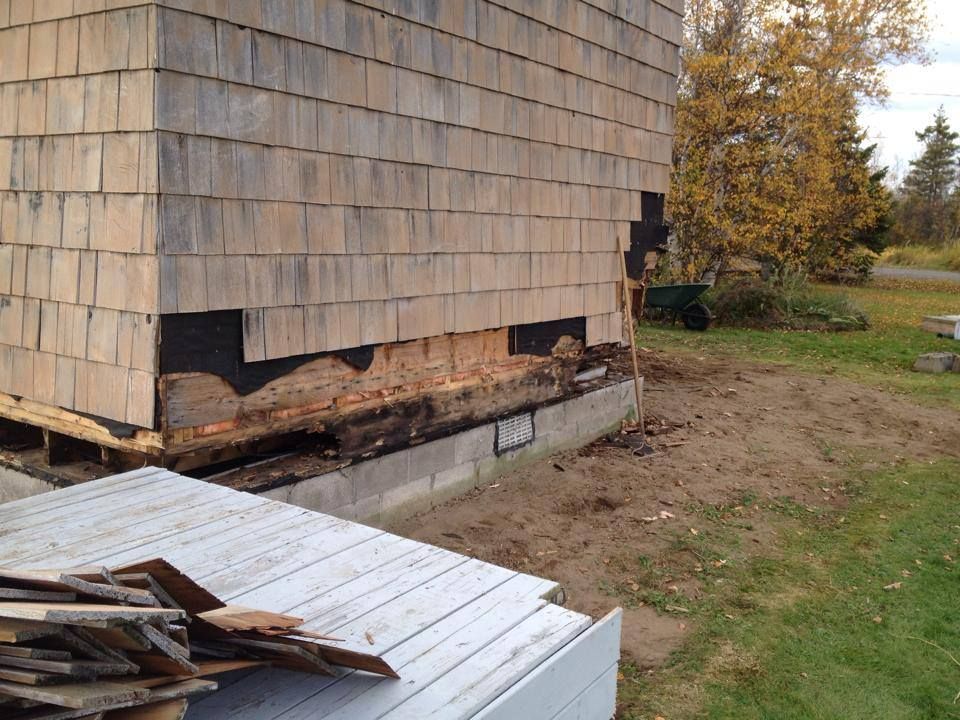 A house with a lot of wood on the side of it