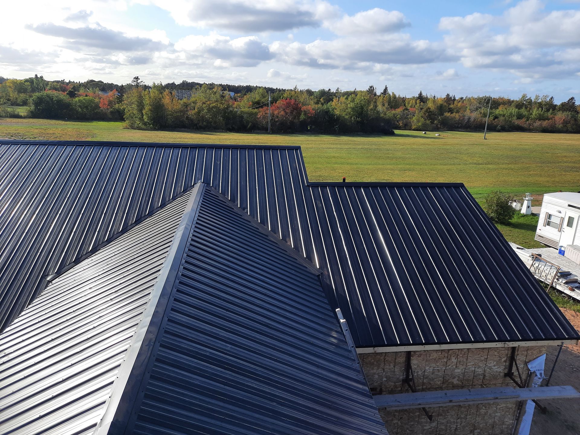 An aerial view of a roof with a field in the background