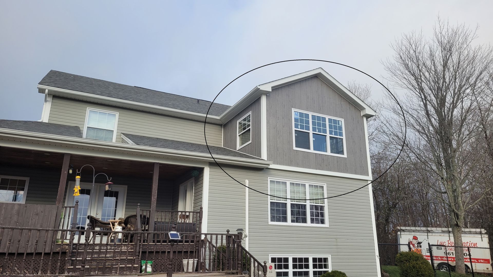 A large house with a lot of windows and a porch.
