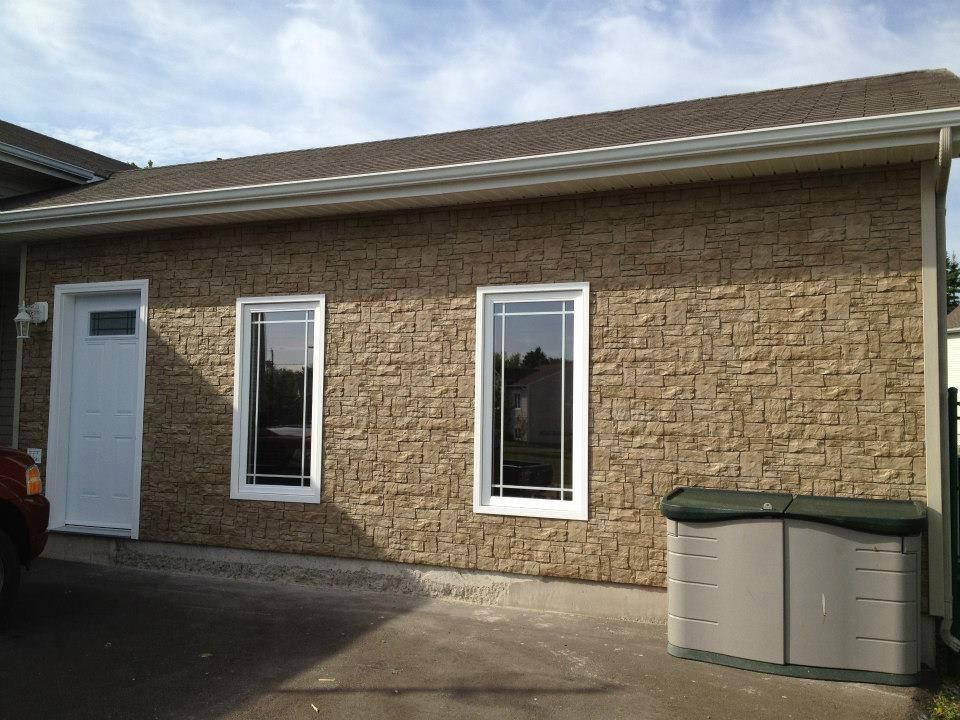 A small house with a car parked in front of it