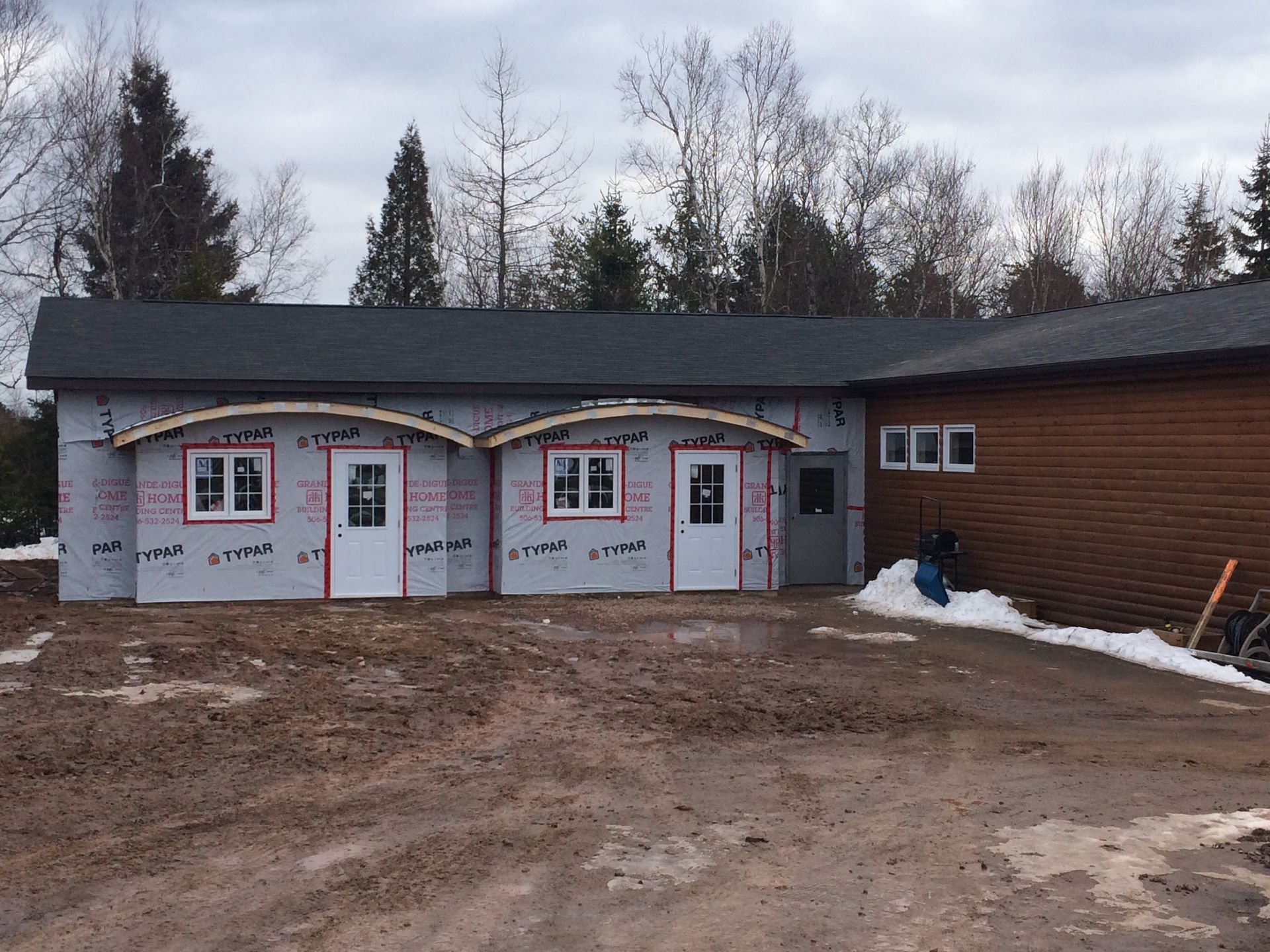 A house that is being built with a lot of windows and doors