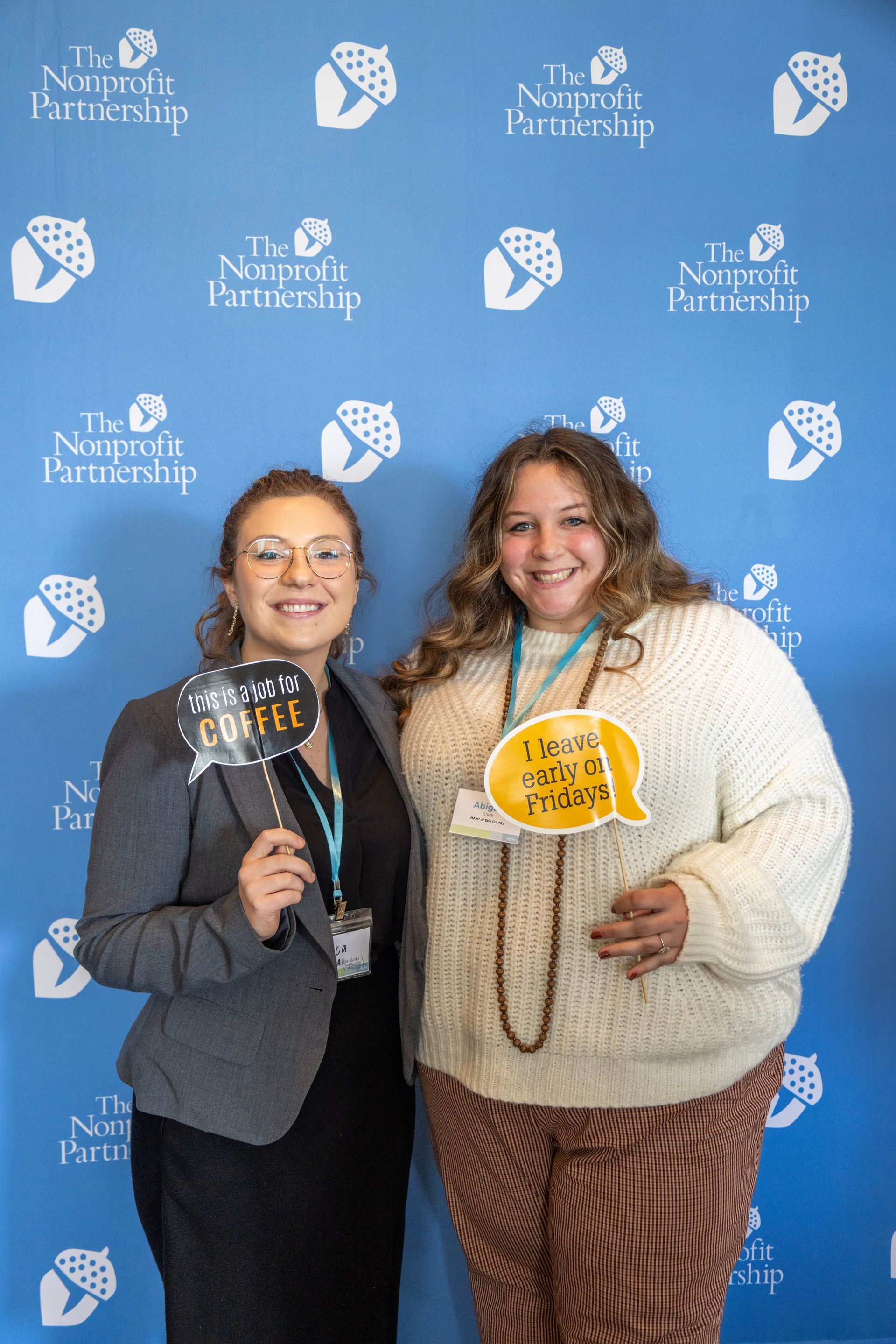 Two people stand in front of a blue
