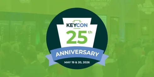 Logo for KeyCon 25th Anniversary on May 19 & 20, 2024, featuring a stylized keystone shape over a blurred event background.