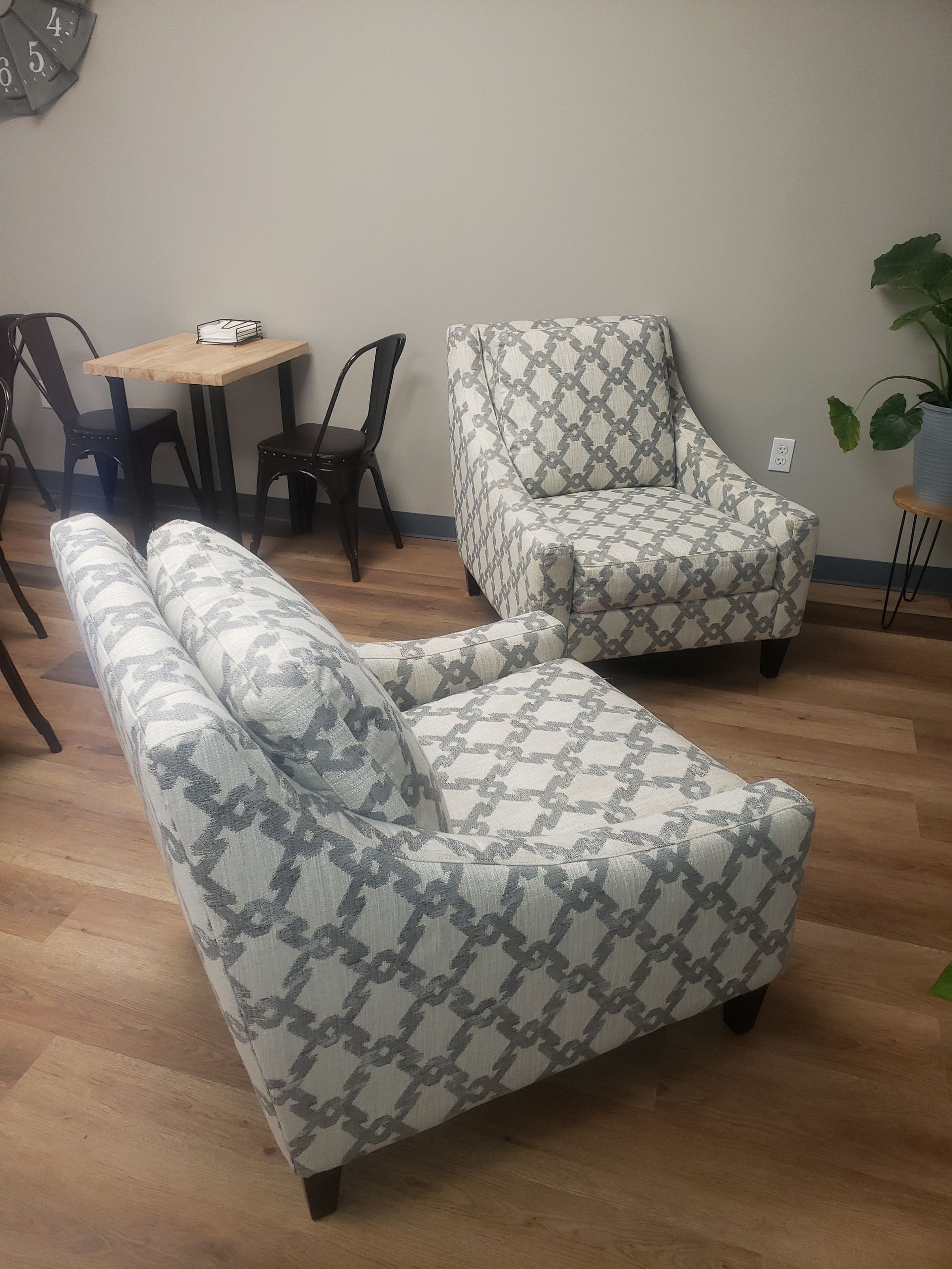 A living room with two chairs and a table.
