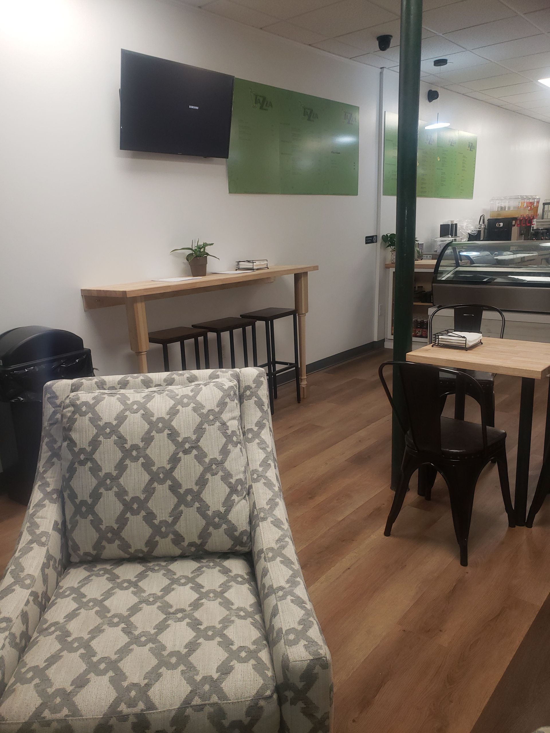 A chair is sitting in a room with tables and chairs.