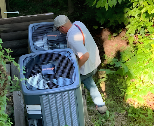 Tools and a yellow toy vehicle in front of an air conditioning unit.