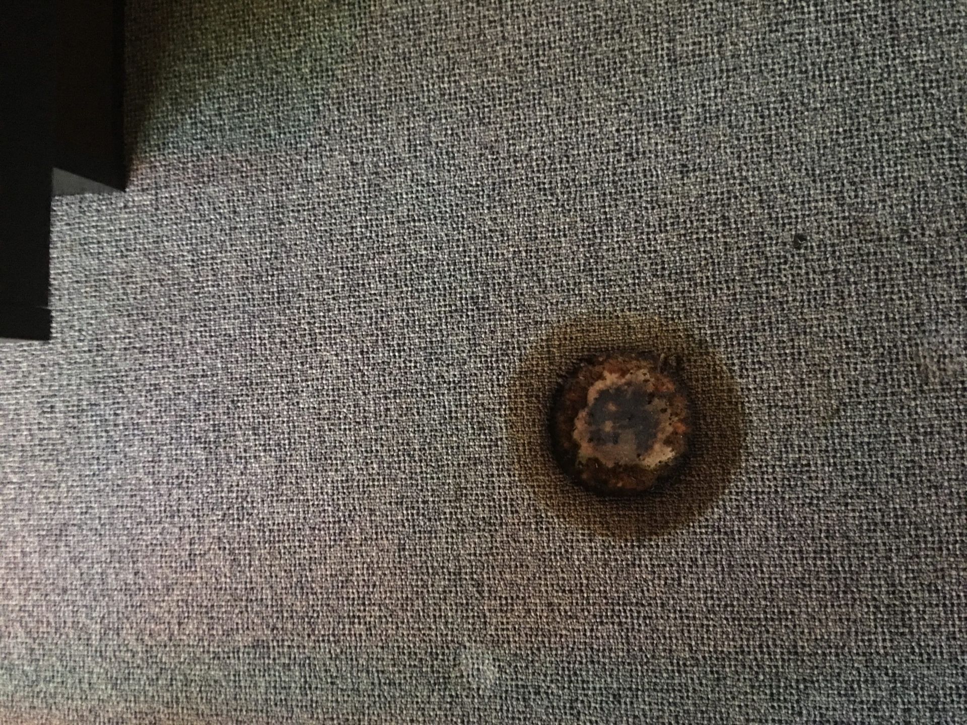 A man in a suit and hard hat is talking to a construction worker at a construction site.