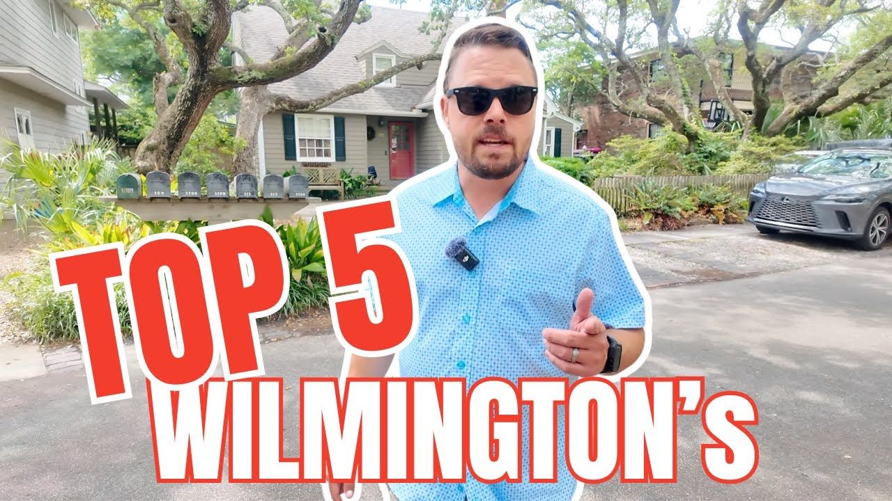Man in blue shirt and sunglasses, in Wilmington, NC, in front of houses, with 